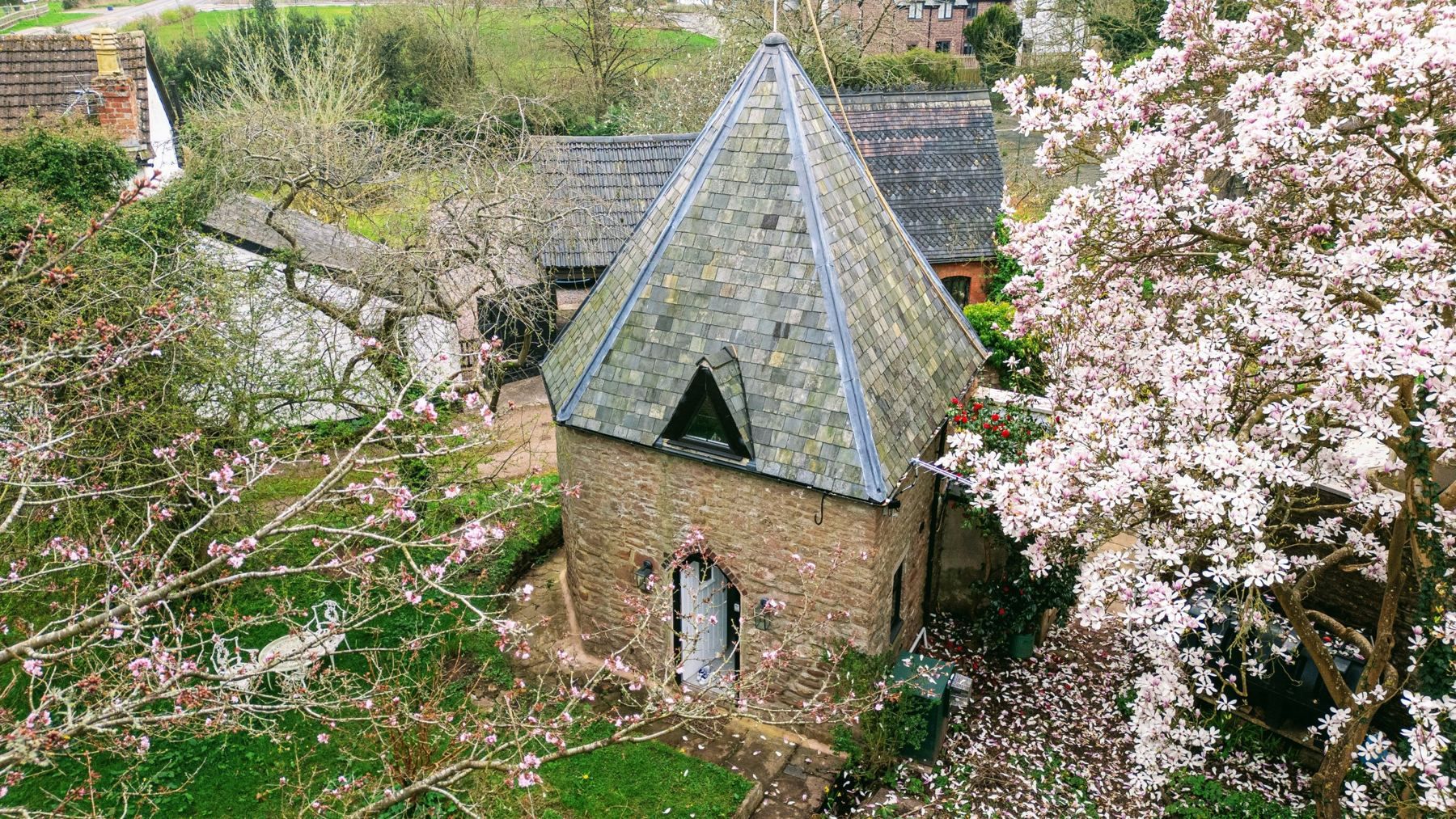 Fairy Cottage's stone turret under the magnolia, at Lea Hall